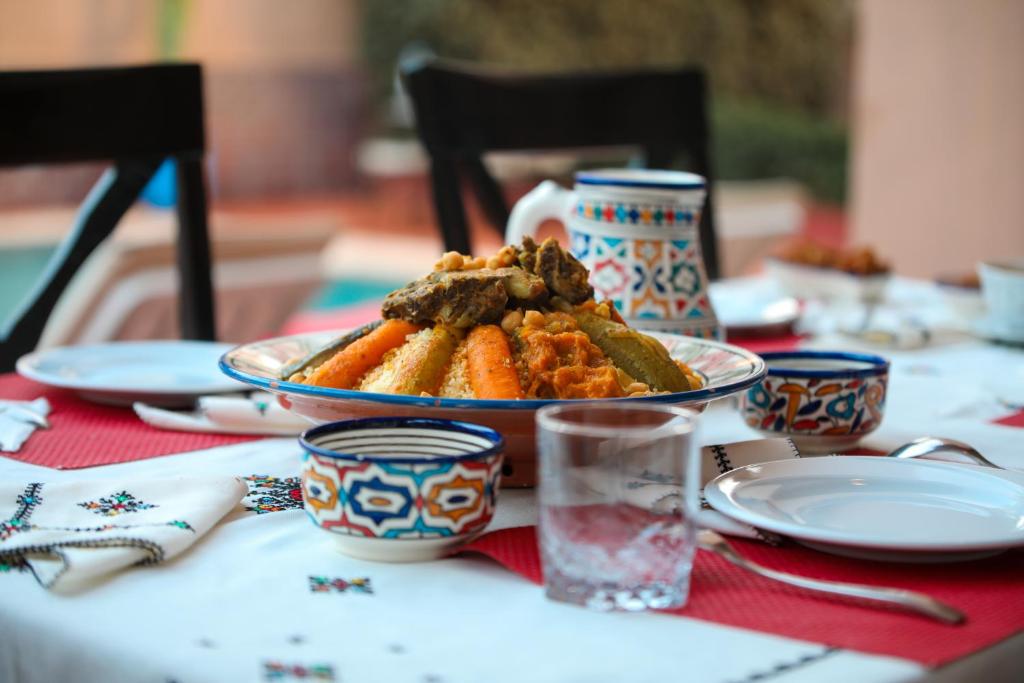 a table topped with a plate of food on a table at Villa Sable de Mirleft Luxury Apartment in Mirleft