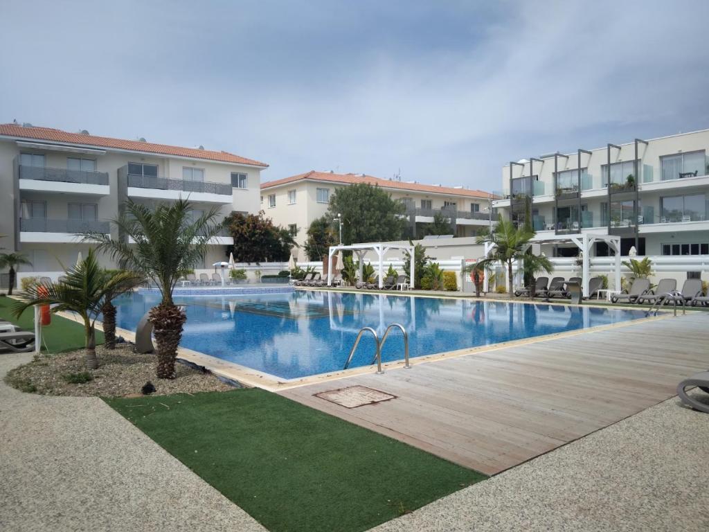 a large swimming pool in front of a building at Sweet Retreat in Paralimni