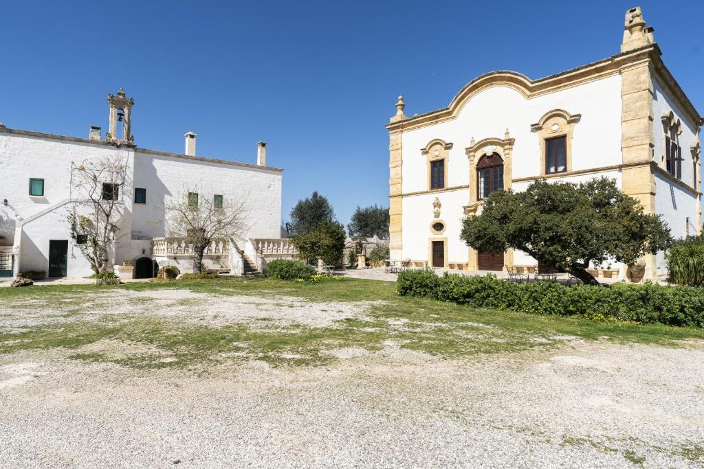 an old building with a large yard in front of it at Suite Dimora Storica Maccarone in Fasano