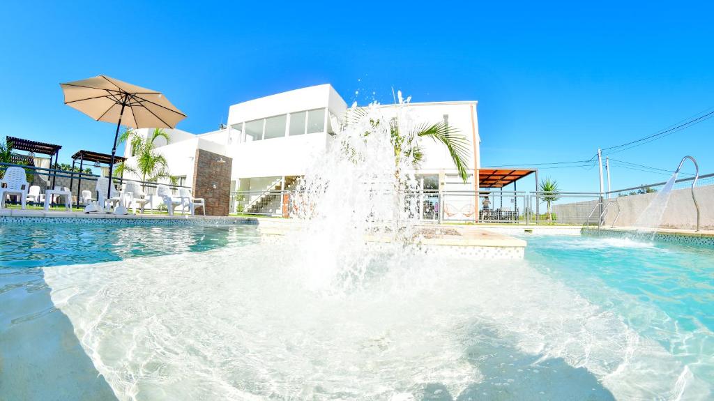 a fountain in a pool in front of a building at Roseus Hotel Boutique in Miramar