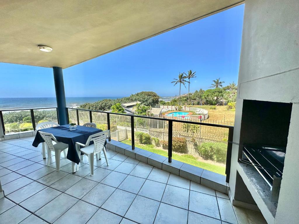 a balcony with a table and a view of the ocean at Ocean Breeze 7 in Margate