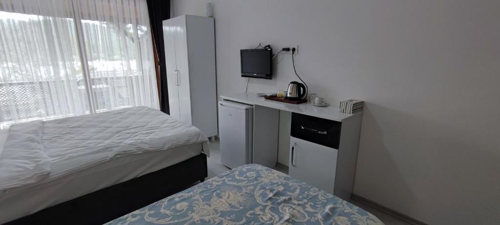 Postel nebo postele na pokoji v ubytování Kaptanhan Pansiyon