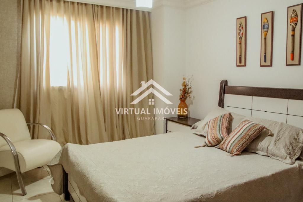 a bedroom with a bed and a chair and a window at Ed. Golden palace in Guarapari