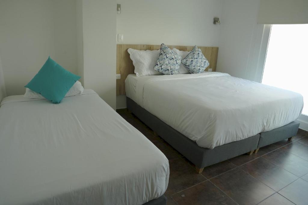 Postel nebo postele na pokoji v ubytování Hotel Caribbean Cartagena