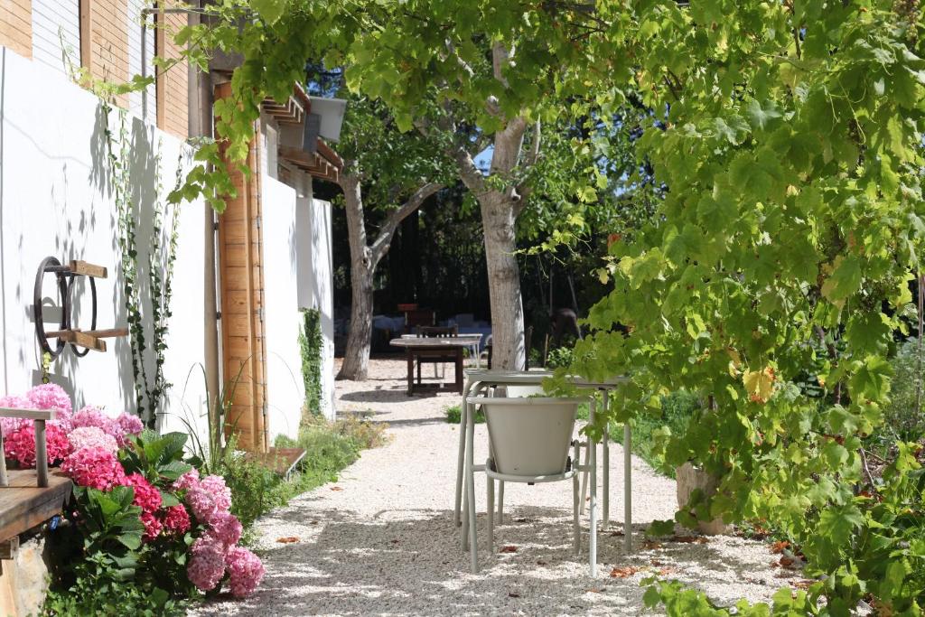 een tuin met een stoel en wat bloemen en bomen bij ribeira dos marinheiros amarelo in Sintra