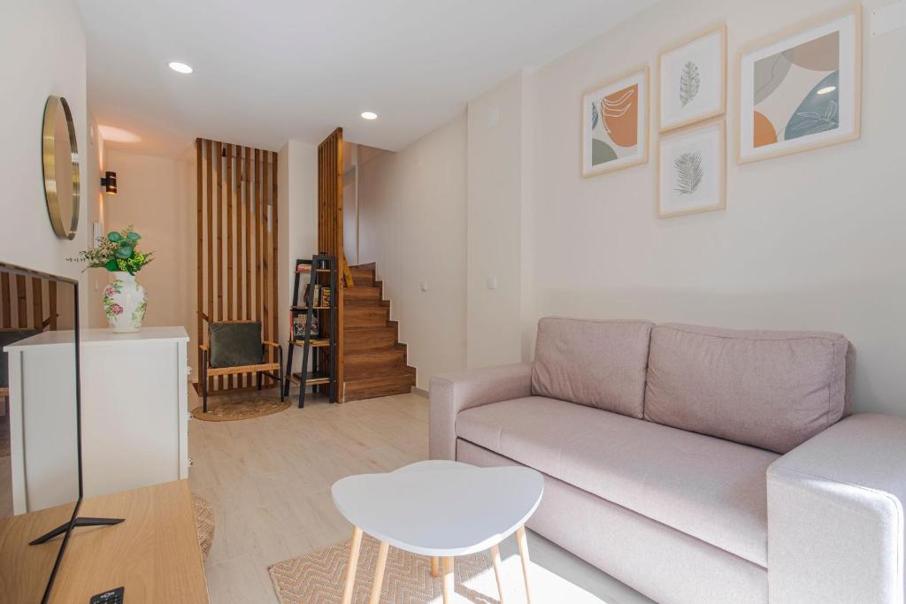 a living room with a couch and a table at Casa de Santa Maria in Setúbal