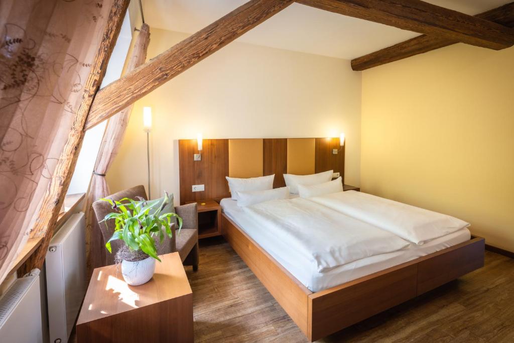 a bedroom with a large bed in a room at Altstadthof Freinsheim in Freinsheim
