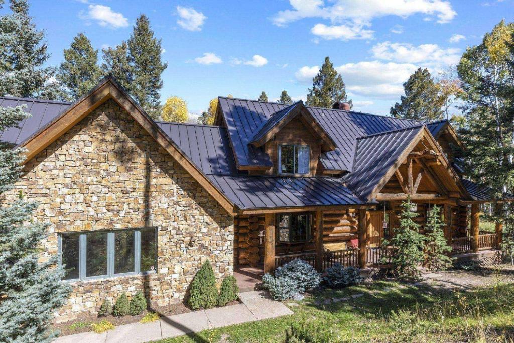 a log home with a metal roof at Sneffels in Telluride