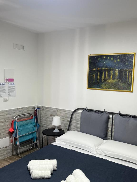 a bedroom with a bed with towels on it at Truly Apulia in Bari