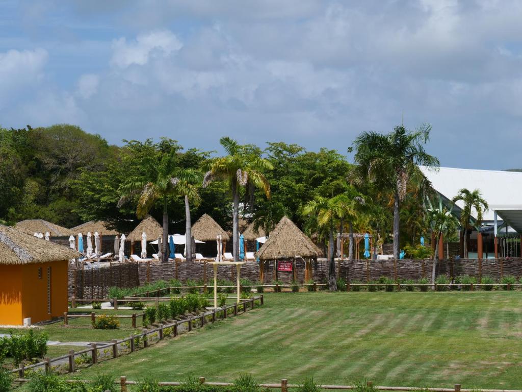 a resort yard with a playground and palm trees at Village Kawann - Toumalacai 246 in Grand-Bourg