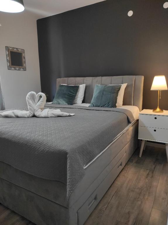 a bedroom with a large bed with blue pillows at Apartments Bucića Dvori in Starigrad-Paklenica