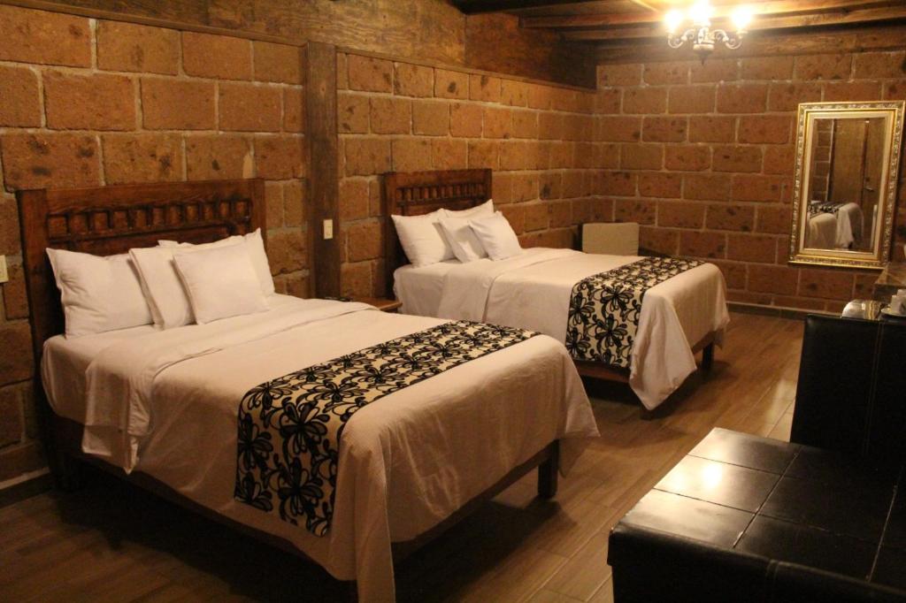 Postel nebo postele na pokoji v ubytování Hotel Real Nirvana