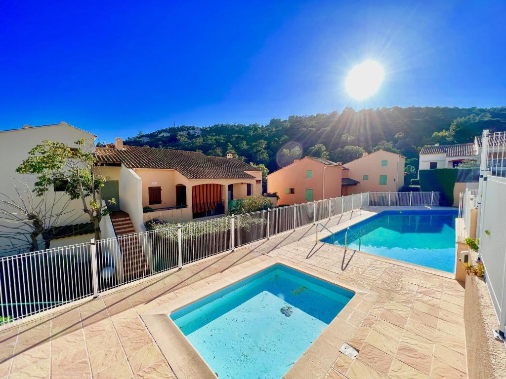 une piscine au milieu d'une maison dans l'établissement Appartement Les Lauriers, à Cavalaire-sur-Mer