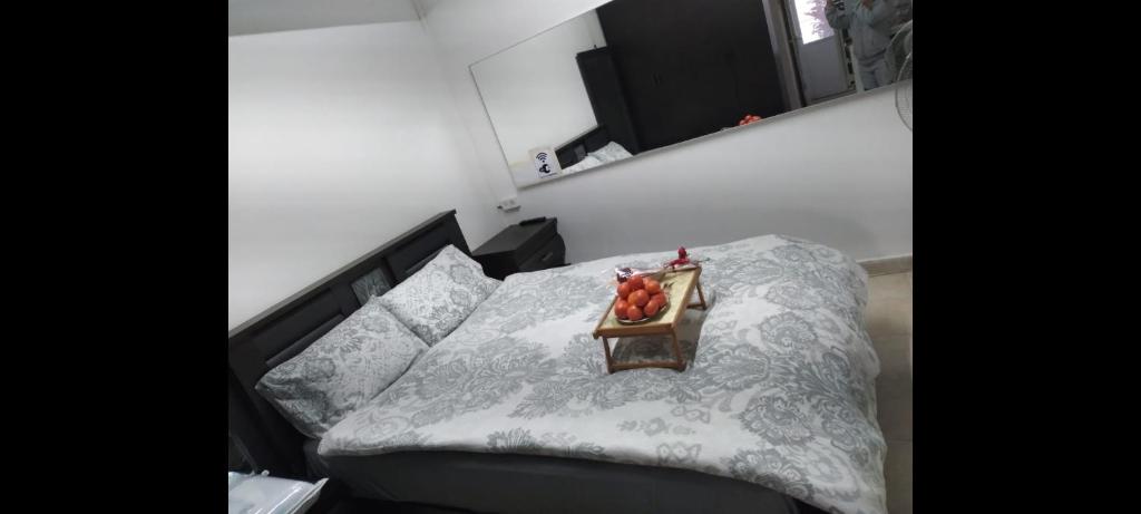 a bedroom with a bed with a bowl of fruit on it at יחידת דיור שקטה נעימה in Nahariyya