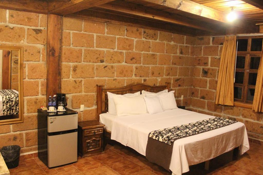Postel nebo postele na pokoji v ubytování Hotel Real Nirvana