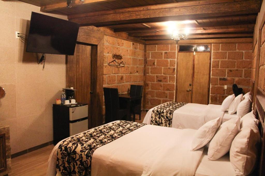 Postel nebo postele na pokoji v ubytování Hotel Real Nirvana