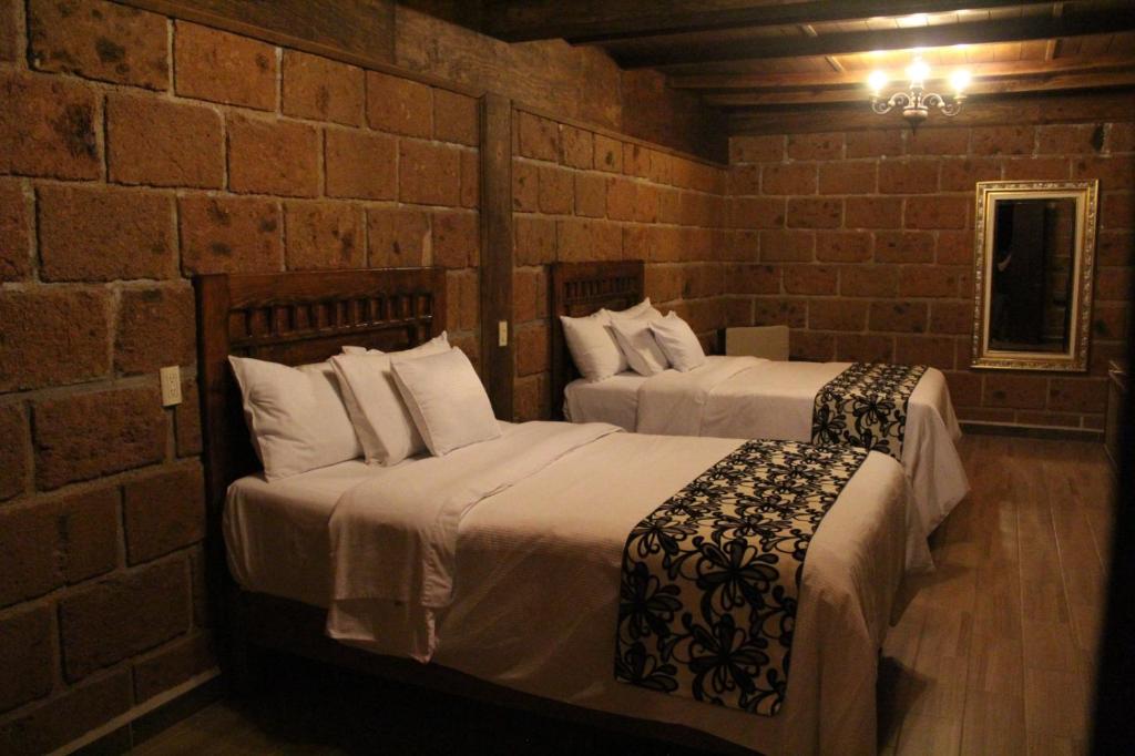 Postel nebo postele na pokoji v ubytování Hotel Real Nirvana