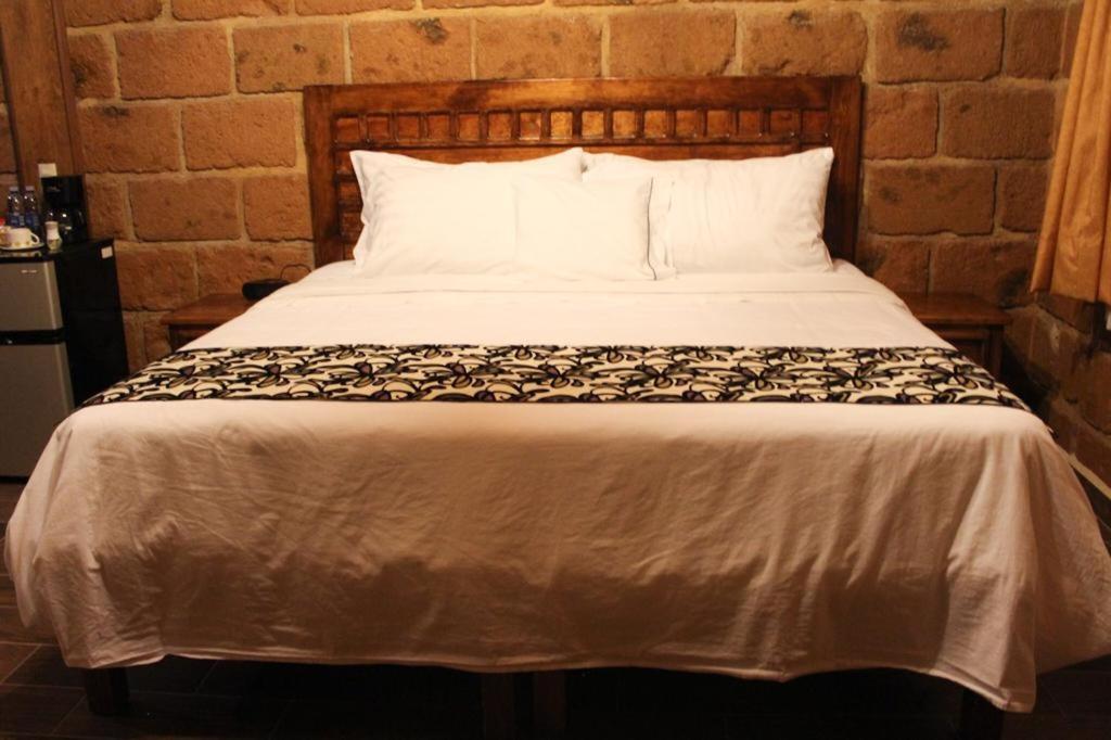 Postel nebo postele na pokoji v ubytování Hotel Real Nirvana