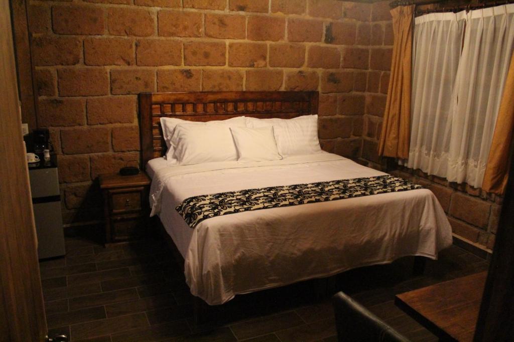 Postel nebo postele na pokoji v ubytování Hotel Real Nirvana
