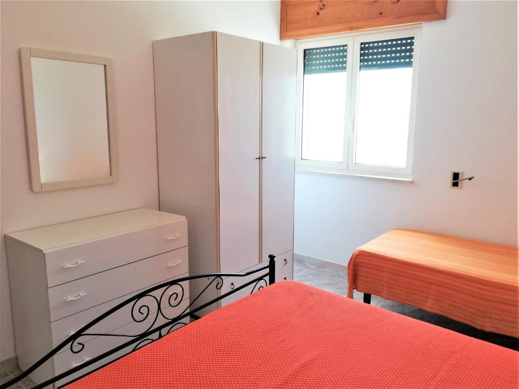 Postel nebo postele na pokoji v ubytování 054 e 055 Spiaggia direttamente sulla spiaggia di SalentoInVacanza.Com