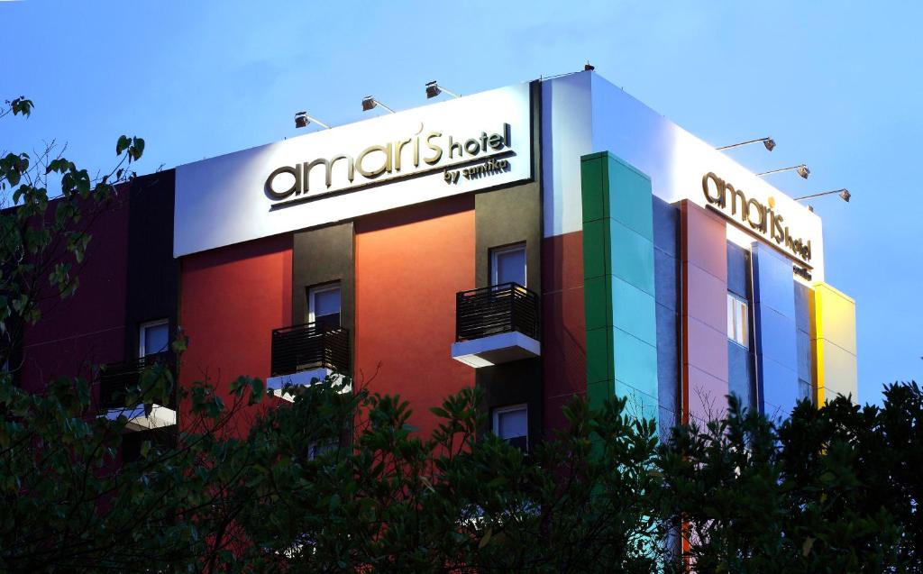 a building with a sign on the side of it at Amaris Hotel Panakkukang in Makassar