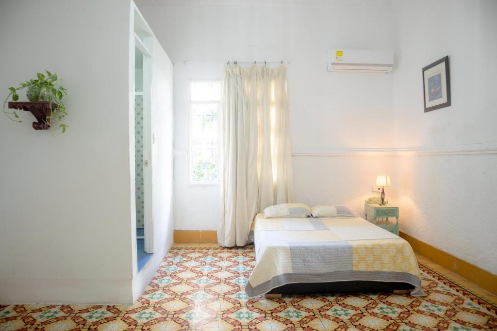 Schlafzimmer mit einem Bett und einem Fenster in der Unterkunft Casa Colonial en Manga in Cartagena de Indias