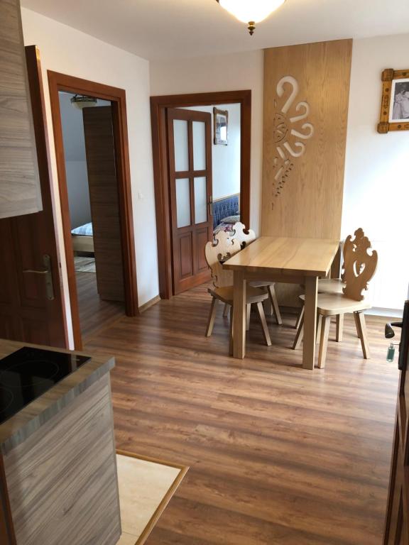a kitchen and dining room with a table and chairs at Apartamenty u Ani in Ząb