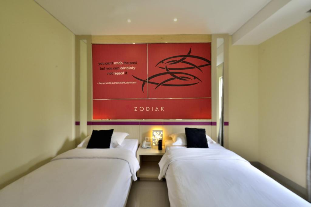 Postel nebo postele na pokoji v ubytování Zodiak Kebon Kawung by KAGUM Hotels