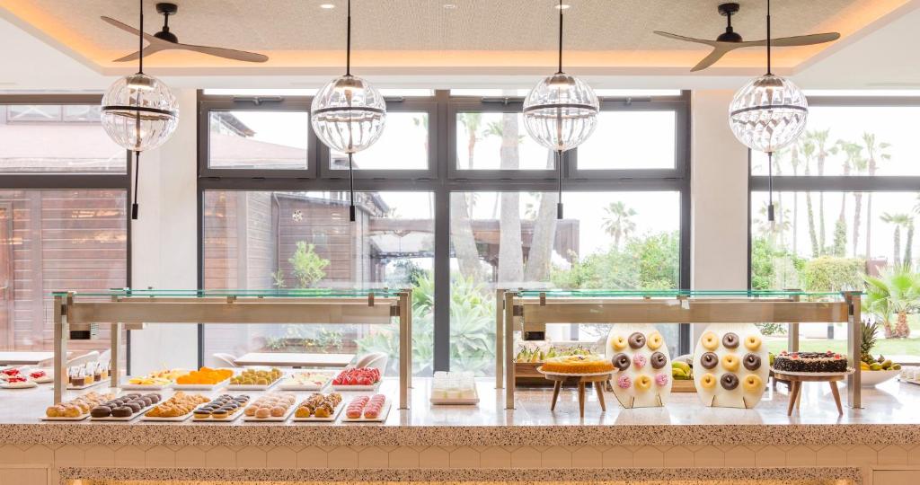 a bakery with many different types of donuts on display at Ilunion Islantilla in Islantilla