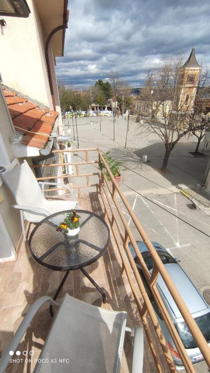a balcony with a table and chairs on a patio at Вила Радеви in Obzor