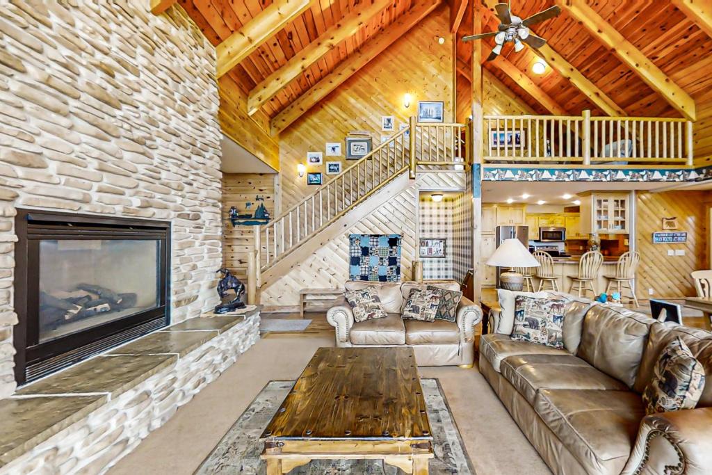 a living room with a couch and a fireplace at Joining Families at Bear Lake in Garden City