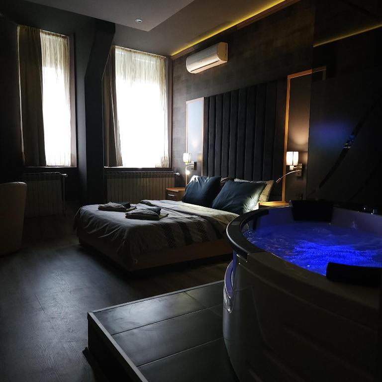 a hotel room with a bed and a tub at IN CLUB in Vrnjačka Banja