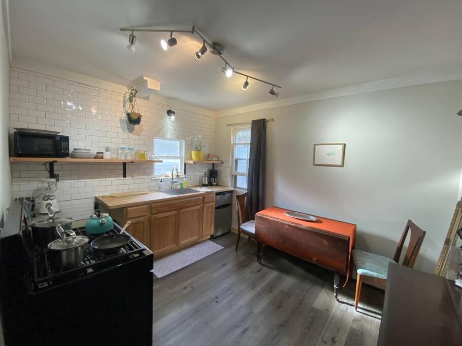 a kitchen with a sink and a stove top oven at Studio Apt w Garden in Kingston