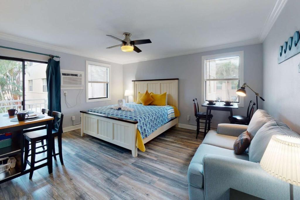a bedroom with a bed and a living room at 805 - Friendly Native Beach Resort in St. Pete Beach