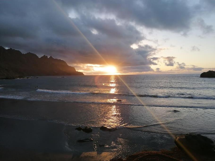 a sunset on a beach with the sun setting at House Rural,Biosphere Reserve World.Taganana.Tfe. in Santa Cruz de Tenerife
