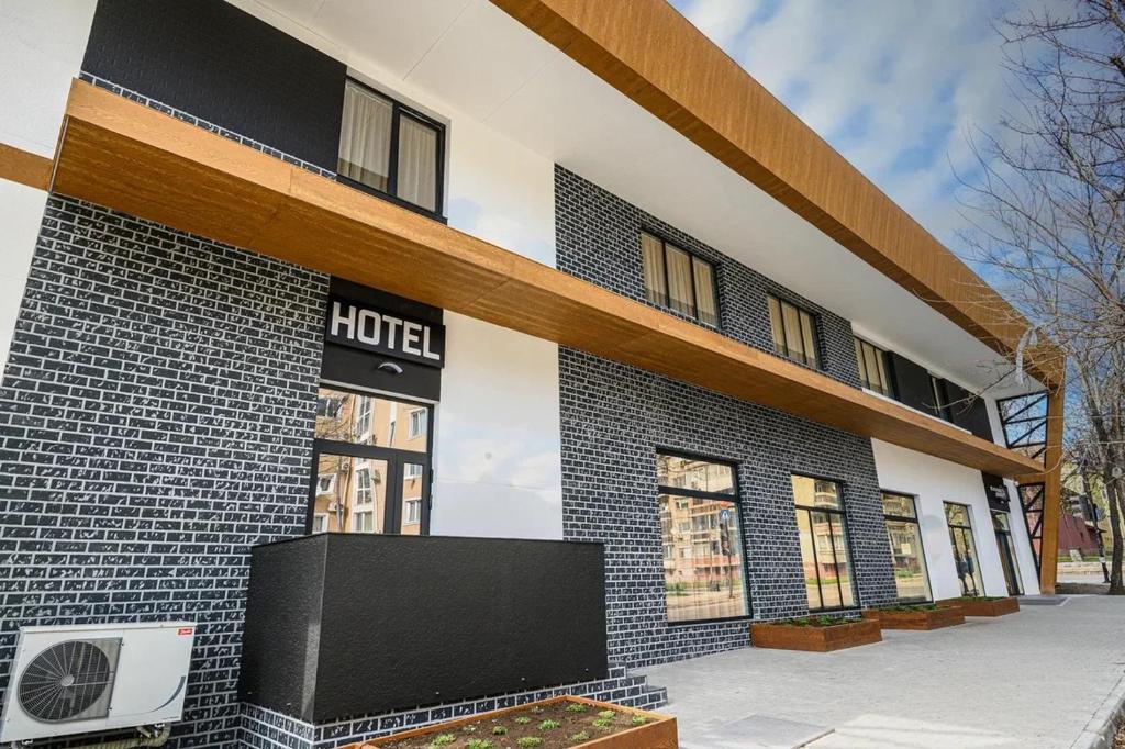 a building with a hotel sign on the side of it at Хотел Добруджа in Shumen