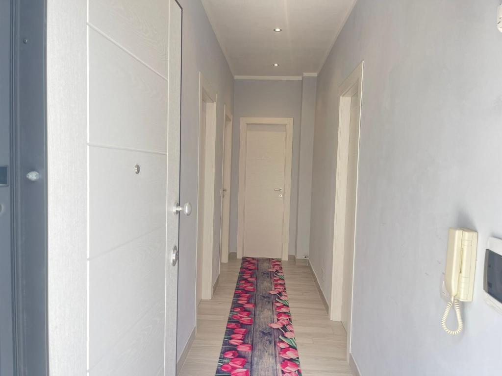 a hallway with a rug on the floor at Sweet Stay in Fiumicino