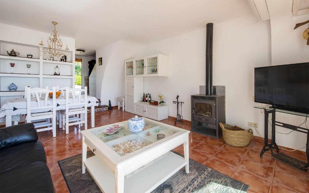 a living room with a table and a fireplace at Casa Angels Tossa de Mar parking y wifi in Tossa de Mar