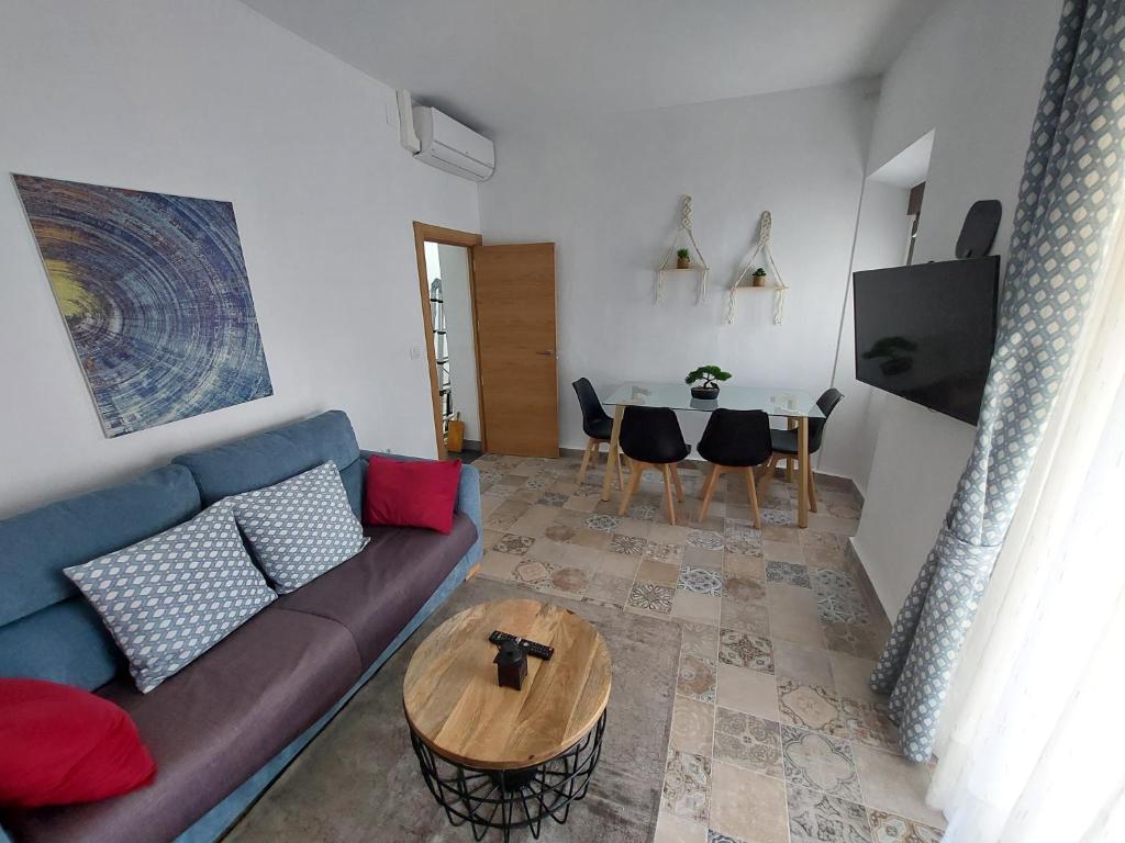 a living room with a couch and a table at apartamentos fuente nueva sande in Cáceres