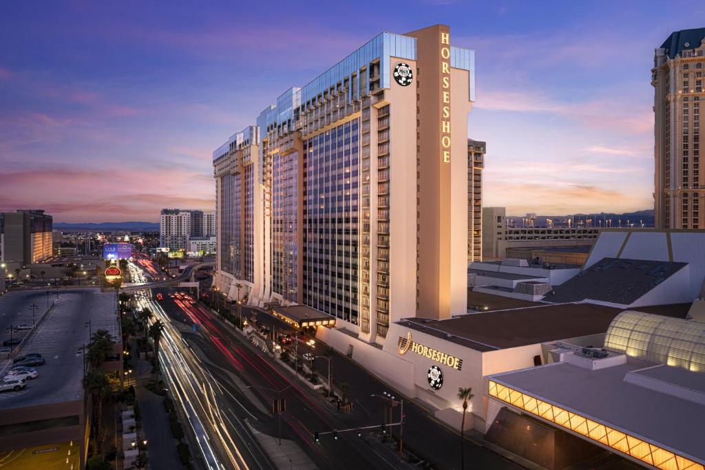 a tall building with a clock on it on a city street at Horseshoe Las Vegas formerly Bally's in Las Vegas