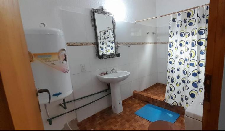 a white bathroom with a sink and a mirror at Mi Buen Relax in Puerto Iguazú