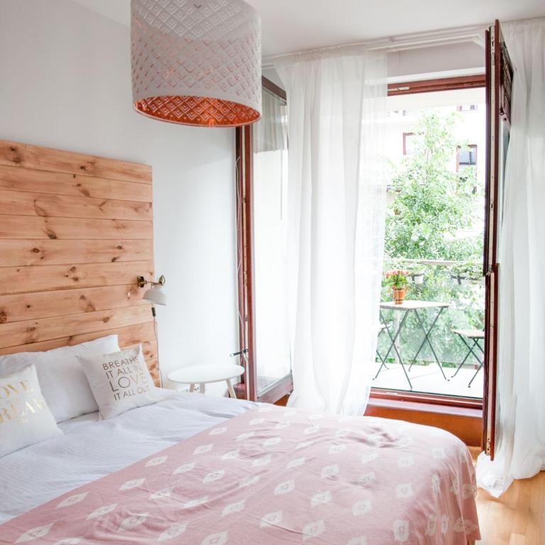 a bedroom with a bed and a large window at Kopernika 8.2 - Market Square in Krakow