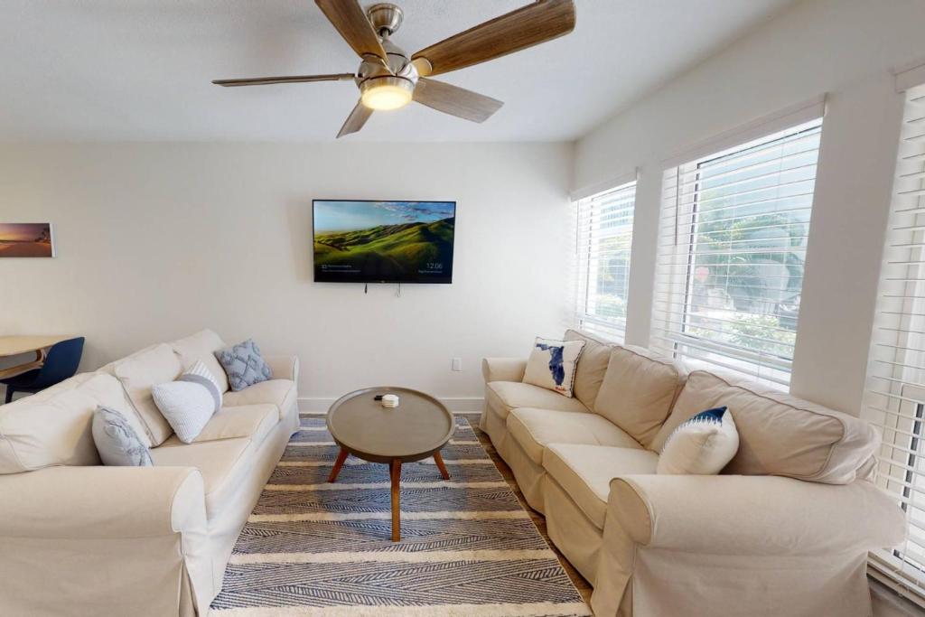 a living room with a couch and a ceiling fan at 247-B - Madeira Beach Yacht Club in St Pete Beach