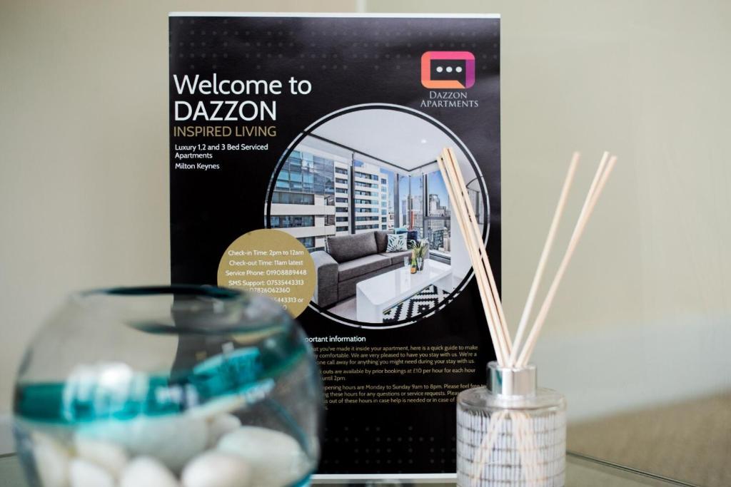 a welcome to dation sign and a glass vase at Dazzon Apartments - HUB - Central MK in Milton Keynes