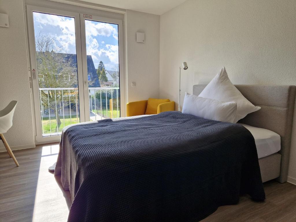 1 dormitorio con cama y ventana grande en Green-Building Appartement, en Bielefeld