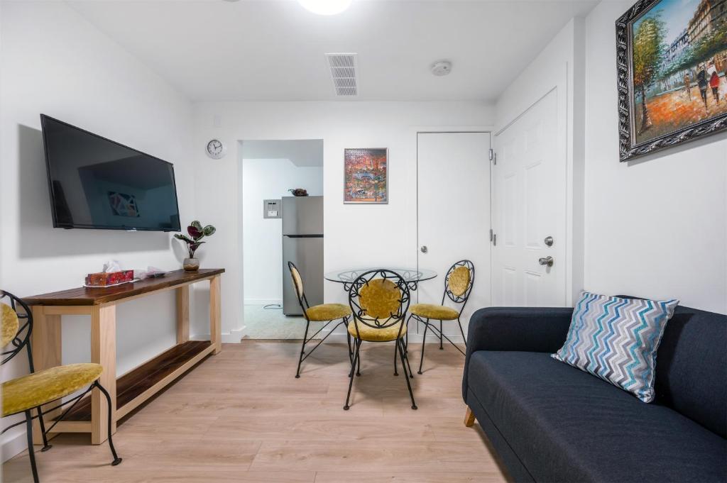 a living room with a couch and a table and chairs at Luxury Delta 2BD Suit on ground floor in Delta