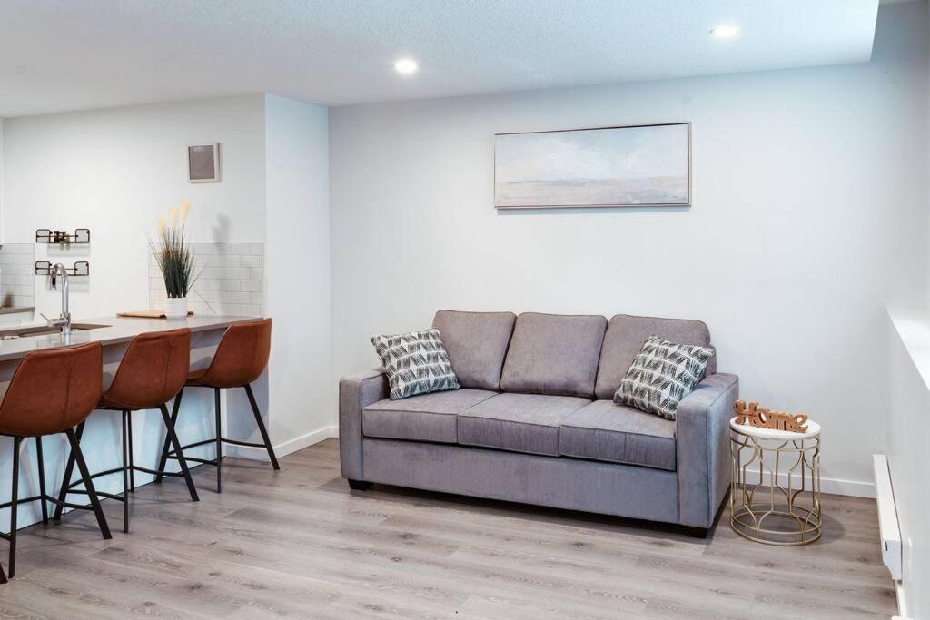 a living room with a couch and a table at Condo in Southeast Calgary in Calgary