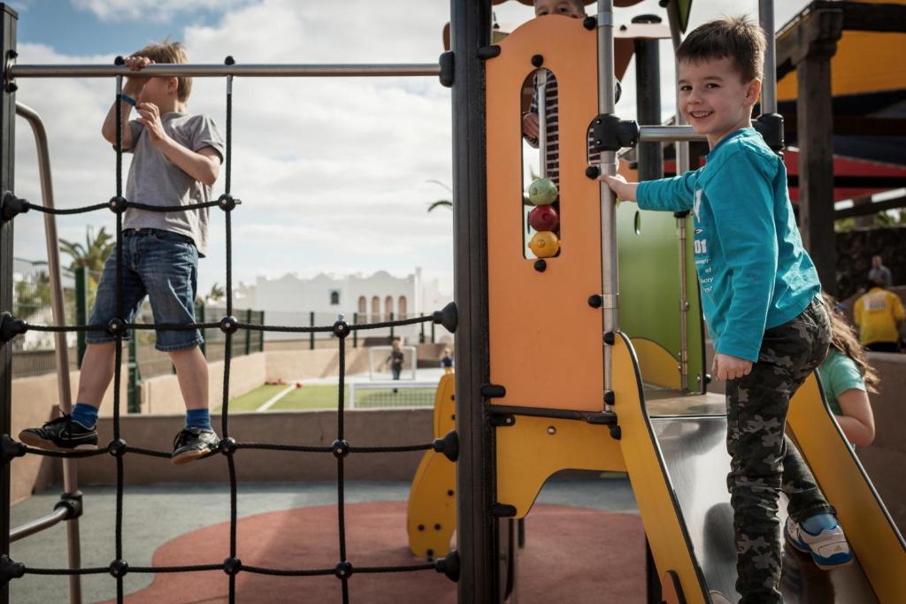 two young boys playing on a playground at Sotavento Beach Club in Costa Calma