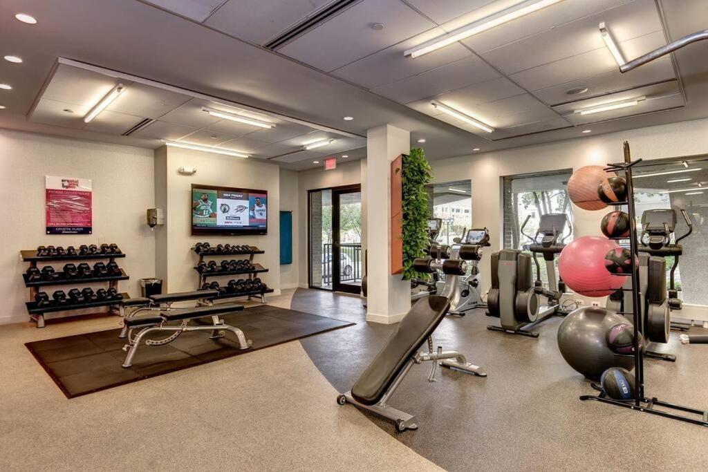 un gimnasio con varias cintas de correr y máquinas en una habitación en Discover an exclusive Condo at Crystal City with gym en Arlington