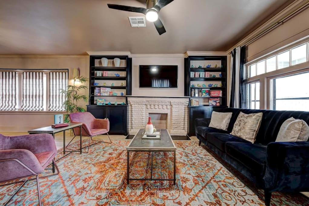 a living room with a couch and a fireplace at Boho Glam Bungalow mins away Western Ave Districts in Oklahoma City